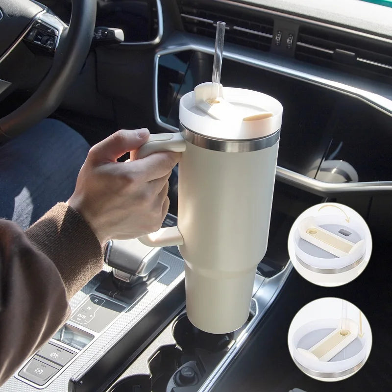 view from passenger seat of driver inserting cup in cup holder. The cu looks large in his hand. The color of the cup is beige. The bottom of the cup fits perfectly in the sup holder in the center console of car.